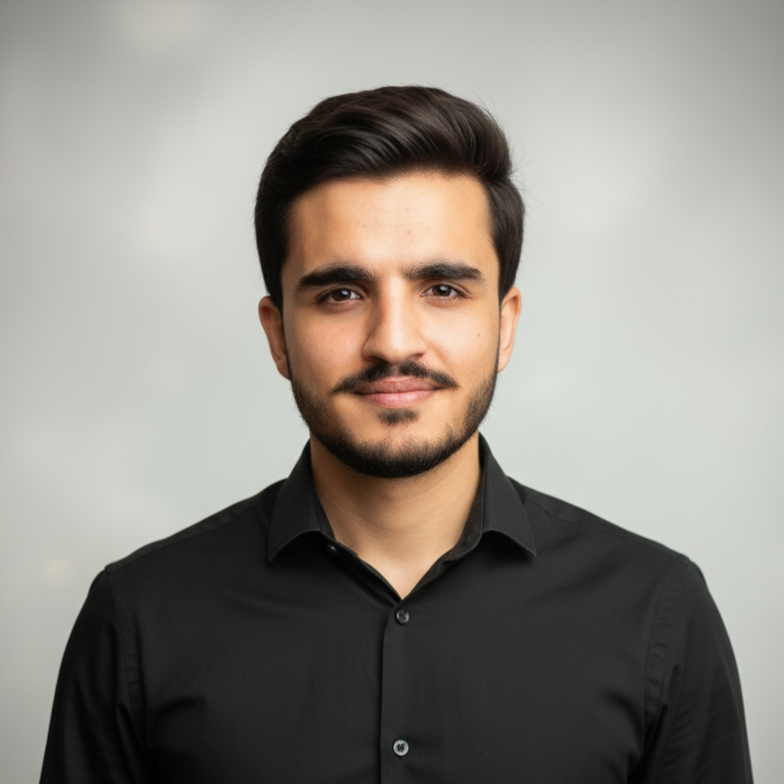 Portrait of a woman with brown hair on a flat gray background.